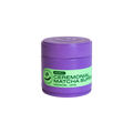 Purple container of ceremonial matcha superfood with green label on a white background
